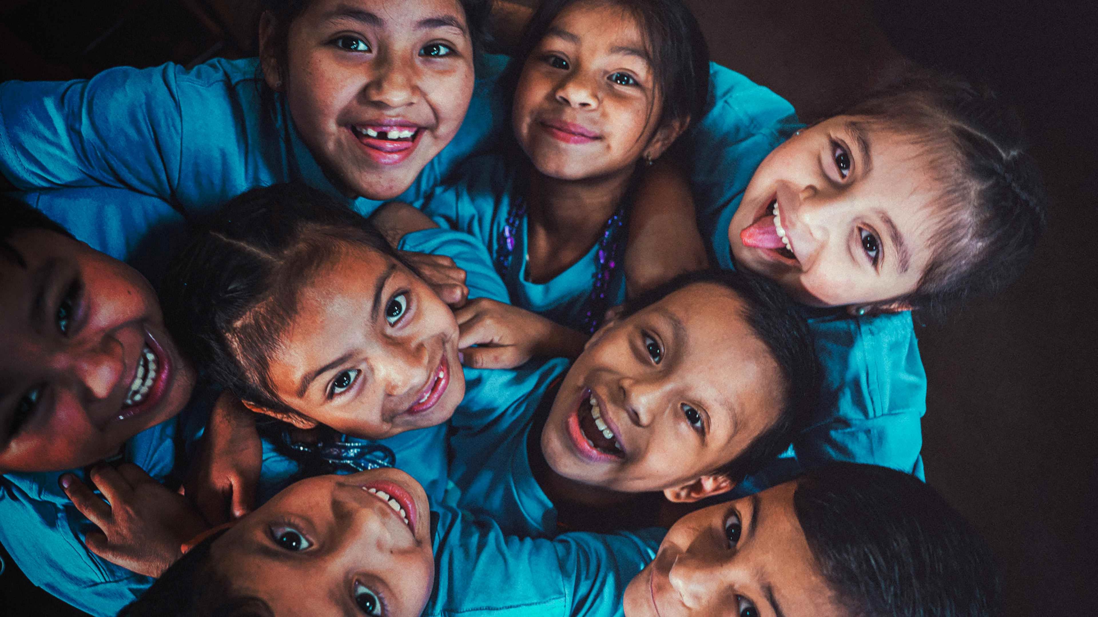 Image of children looking up and smiling